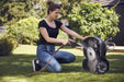 Woman cleaning a Husqvarna Automower 310 Mark II with a hose.